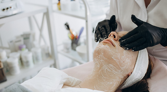 hands-rubbing-chemical-on-face-menu