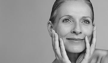 senior-woman-holding-face-1